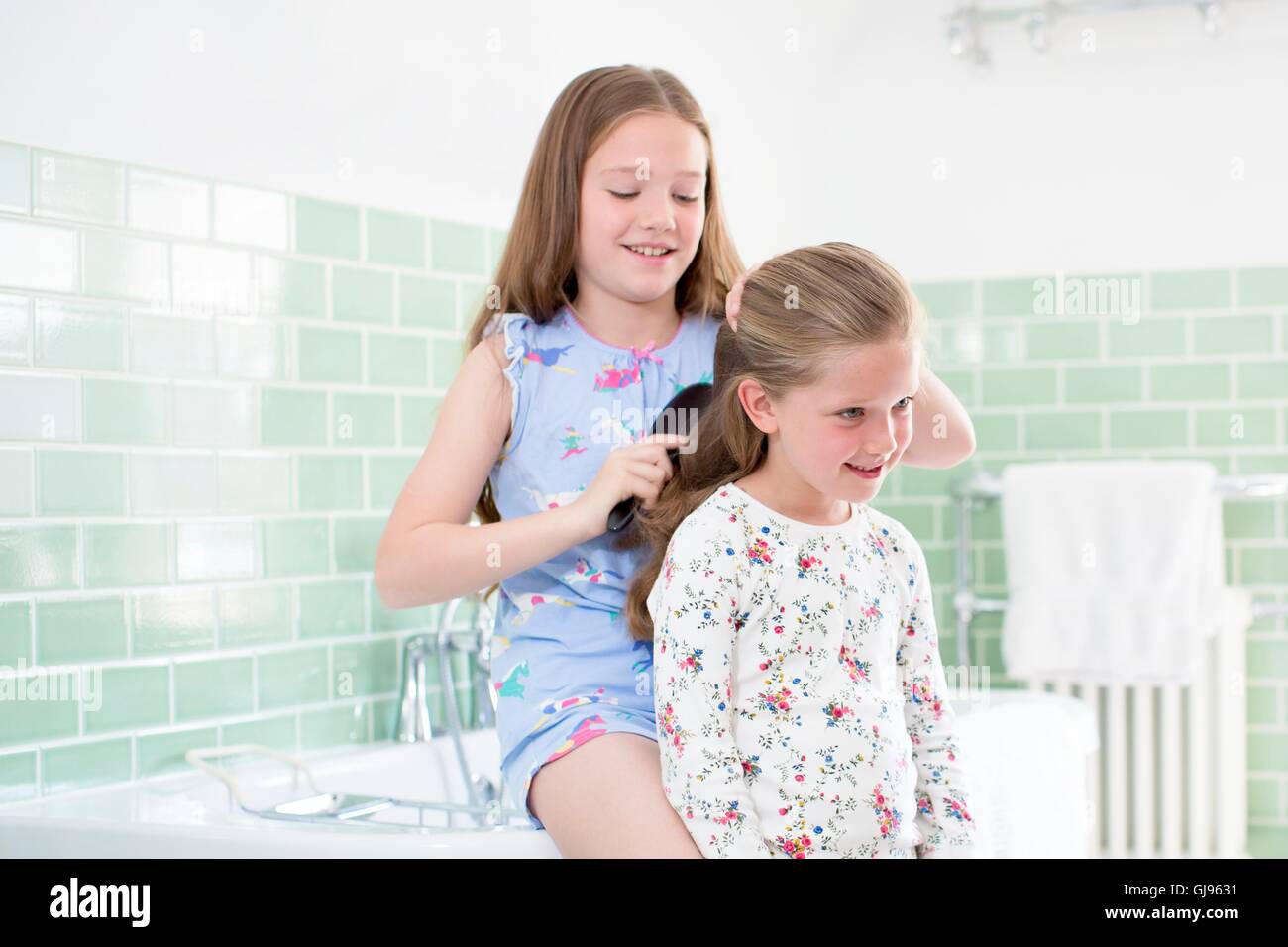 PROPERTY RELEASED MODEL RELEASED Big sister brushing little sisters 