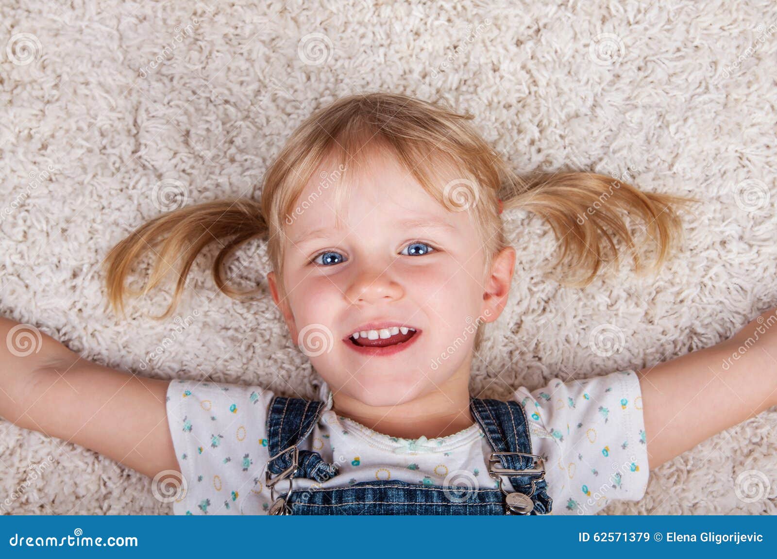 Smiling Cute Kid Girl Lying on White Carpet and Stock Image Image of 