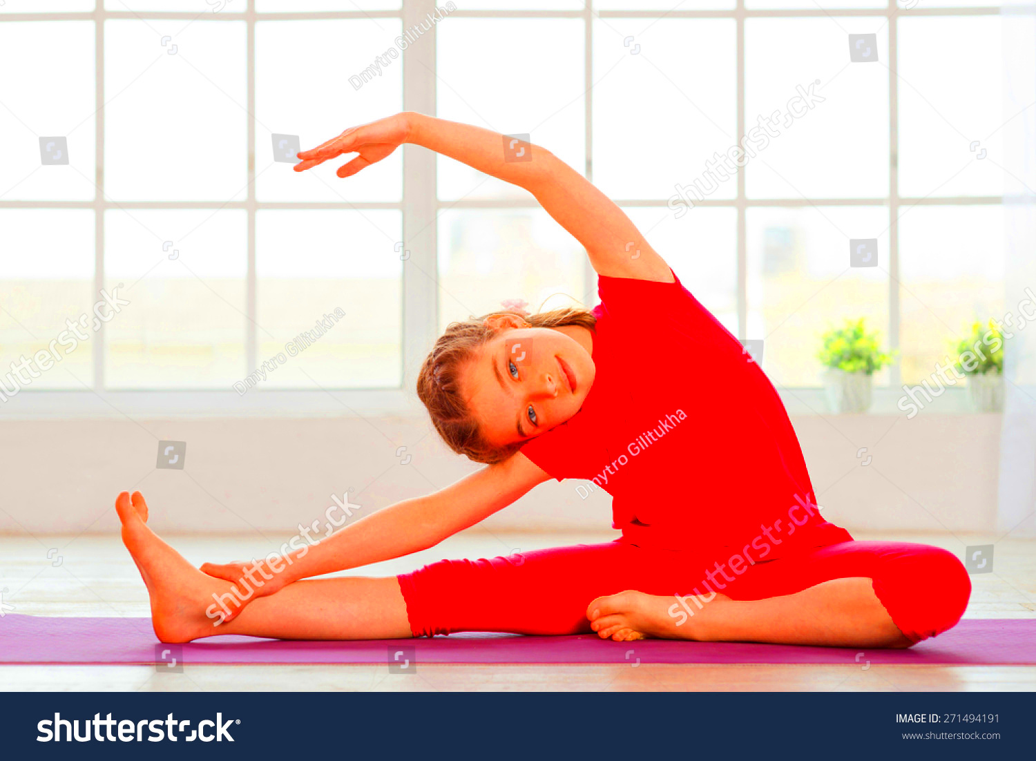 Little Girl Doing Yoga Exercise In Fitness Studio With Big Windows On 