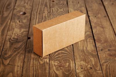 Craft Cardboard Package Box on Stressed Brushed Wooden Table – Free Stock Photo