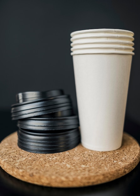 Front view of plastic coffee cups with lids