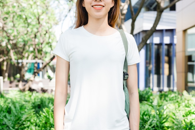 Asian Girl with Long Brown Hair in White Blank T-Shirt Standing in Street