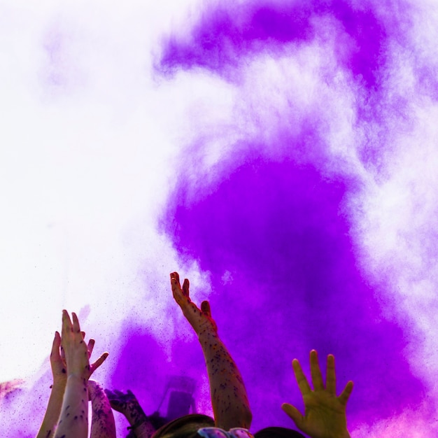 Purple Holi Color Over People Raising Hands and Dancing