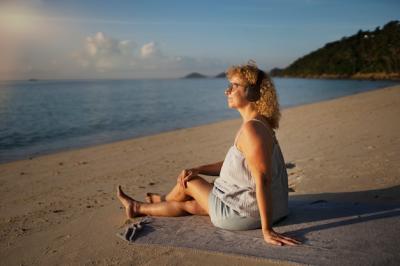 Full shot woman spending a day alone on the beach