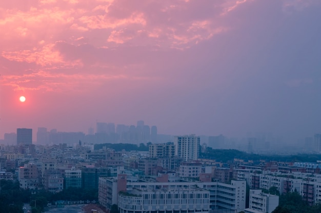 Cityscape at Dusk: Pink Sunset and Cloudy Sky