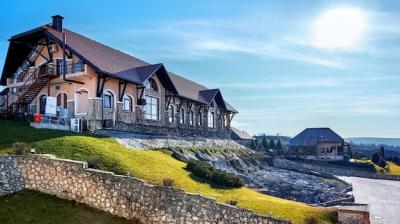 Chateau Vartely Building with Rocky Slope and Grass