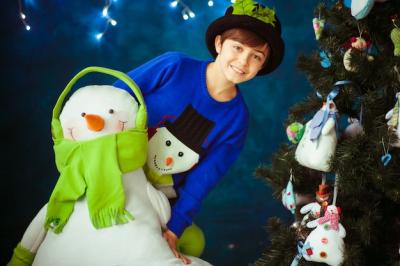 Smiling Boy Hugging Toy Snowman