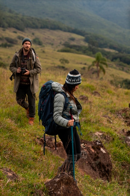 Full shot adventurous couple bivouacking