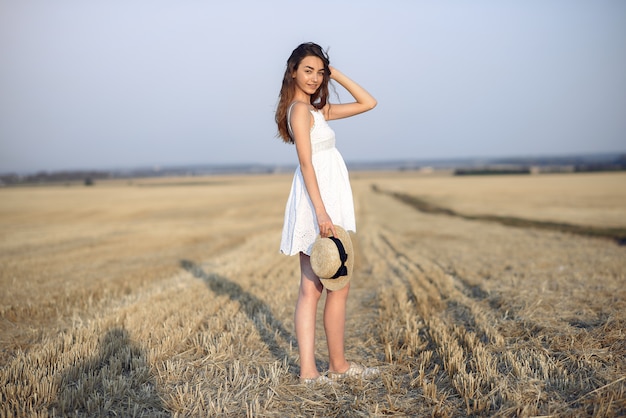 Beautiful elegant girl in a autumn wheat field