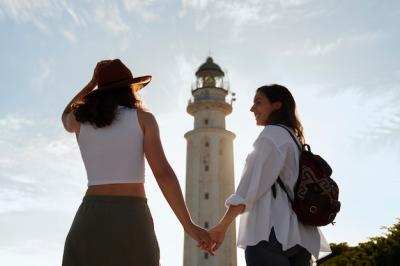 Back view women posing with lighthouse