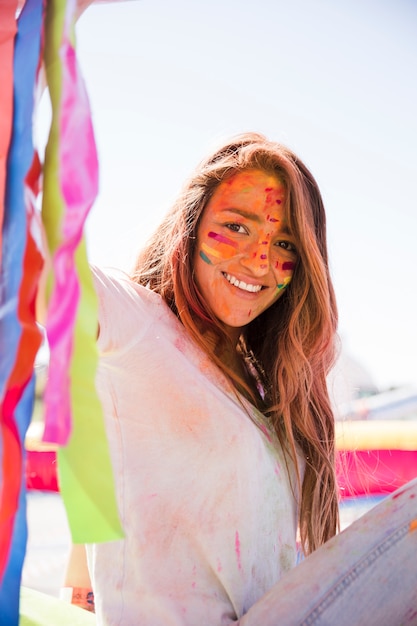 Smiling Young Woman with Painted Face for Holi Celebration – Free Stock Photo