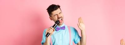 Party and Festive Events Concept: Funny Guy Performs a Karaoke Song