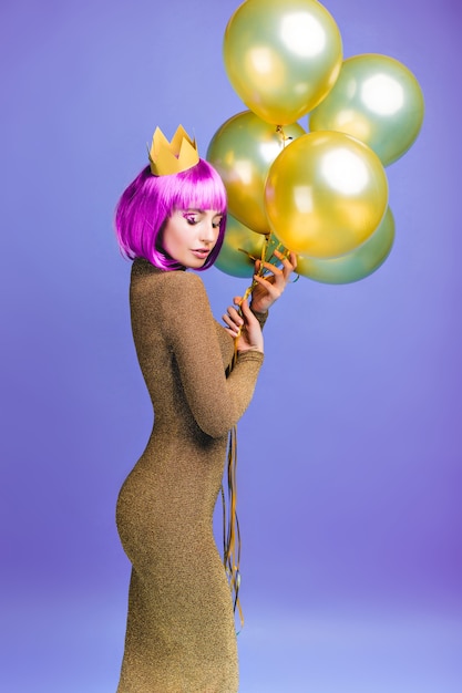 Beautiful Young Woman in Fashionable Dress with Golden Balloons Free Stock Photo