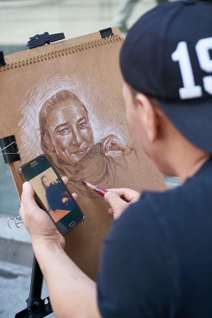 Man Making a Painting with a Mobile in His Hand