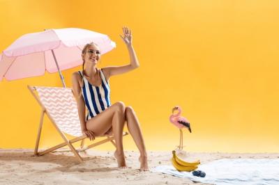 Charming Young Model in Striped Swimsuit Smiles and Looks Away