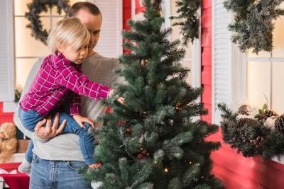 Christmas Celebrations: Father and Daughter Decorating Christmas Tree