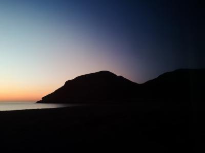 Sunset silhouette of a mountain on the beach