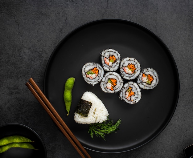 Flat lay maki sushi with rice and chopsticks