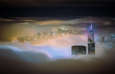 Mesmerizing shot of city skyscrapers in mist at night – Free Stock Photo