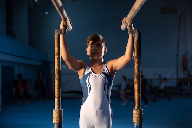 Little Male Gymnast Training in Gym: Flexible and Active