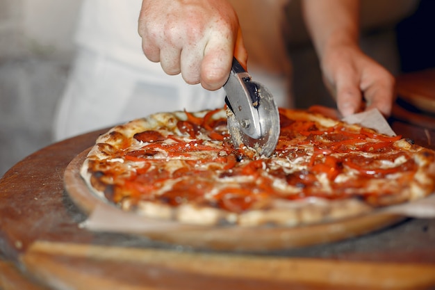 White Uniform Chef Preparing Pizza