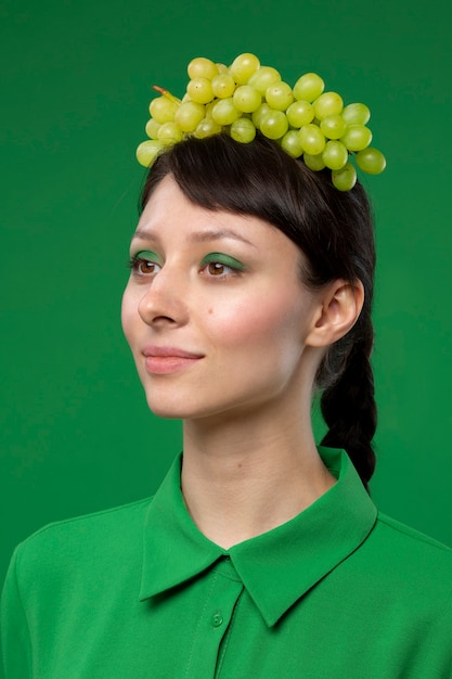 Portrait of woman with grapes on her head