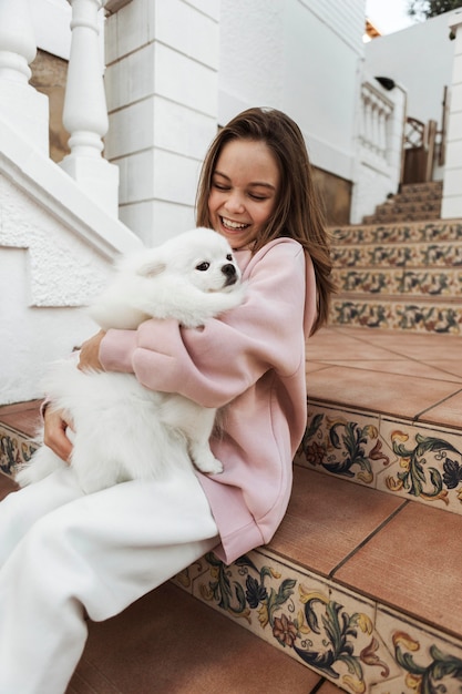 Girl and fluffy dog on the stairs