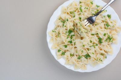 Delicious farfalle pasta with parsley and fork on white plate – Free Stock Photo Download