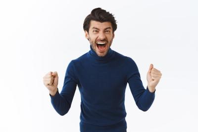 Cheerful Ambitious Goodlooking Bearded Businessman in High Neck Sweater Yelling from Happiness Free Stock Photo