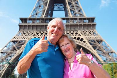 Smiling Elderly Couple with the Eiffel Tower