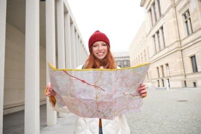 Beautiful Redhead Woman Tourist with City Map Explores Sightseeing Historical Landmark Walking Around