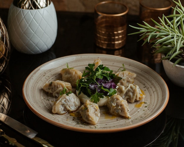 Caucasian Delicious Food Khinkali, Khingal Finely Cooked and Served with Fresh Parsley and Red Basilica Leaves