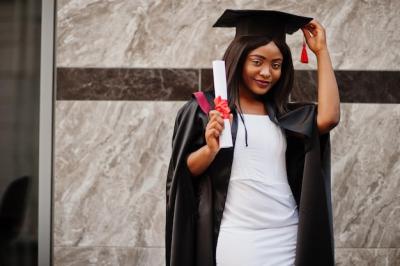 Young African American Student with Diploma Poses Outdoors