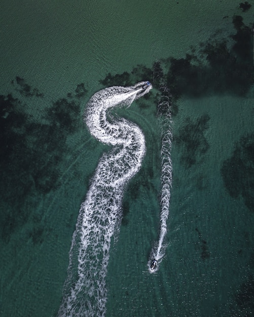 Aerial Shot of Yachts Cruising in the Sea Leaving Splashing Traces