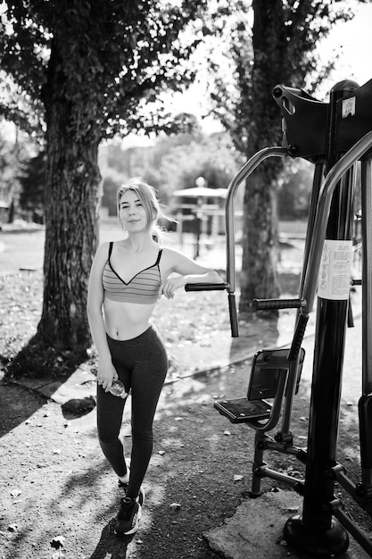 Young Girl Exercising Outdoors on Street Simulators – Sport Fitness Street Workout Concept