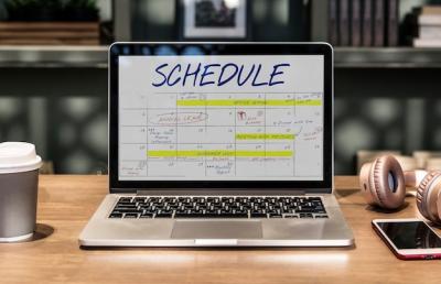 Laptop in a coworking space with schedule – Free Stock Photo Download