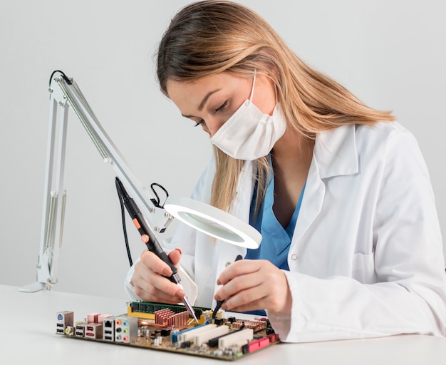 Medium shot woman with face mask working