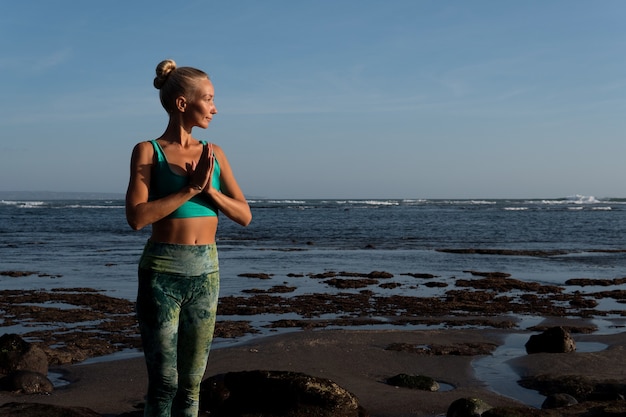 Beautiful Woman Doing Yoga on the Beach