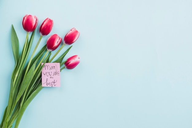 Composition with flowers and cute note for mother’s day
