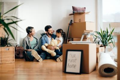 Happy family talking while relaxing on the floor at their new home