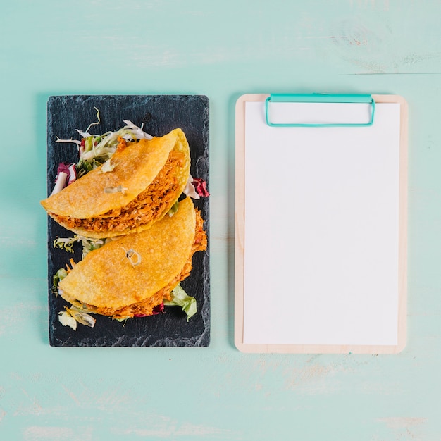 Tacos and clipboard on blue background – Free Stock Photo Download