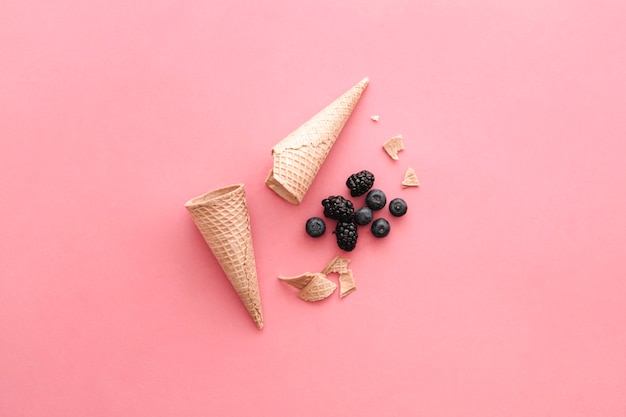 Ice cream concept with cones and fruits