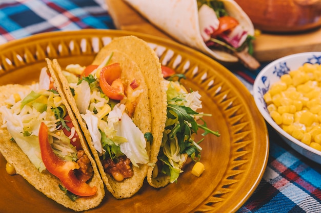 Fresh Tacos with Meat and Vegetables in Brown Plate