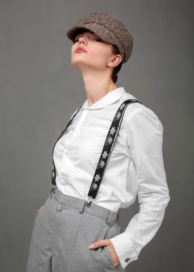 Elegant Female Model in White Shirt and Suspenders: New Femininity Concept