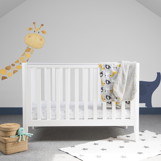 Interior of light baby room with a modern cozy crib and cute animal paintings on a wall