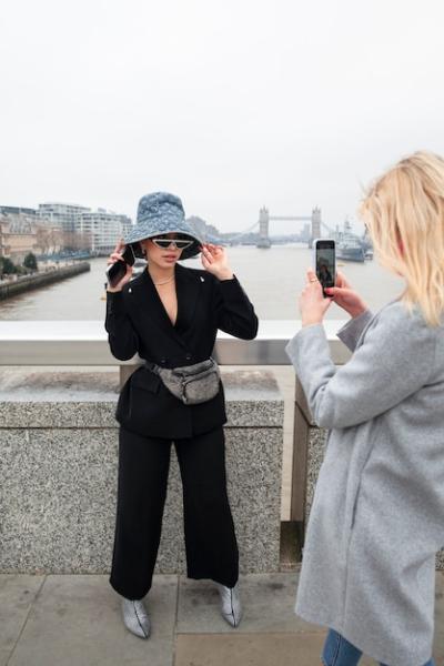 Woman Taking Photo of Internet Celebrity on a Bridge in the City