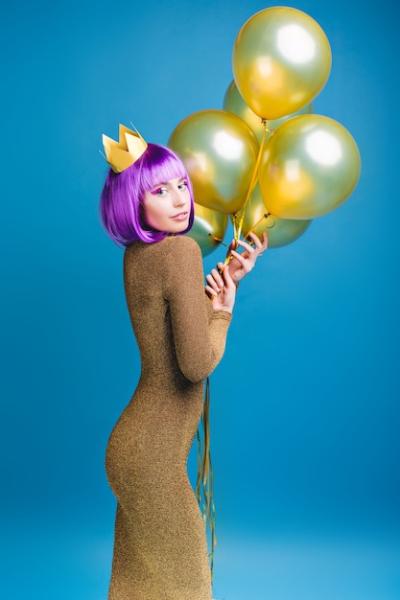 Charming Attractive Young Woman in Luxury Dress with Golden Balloons