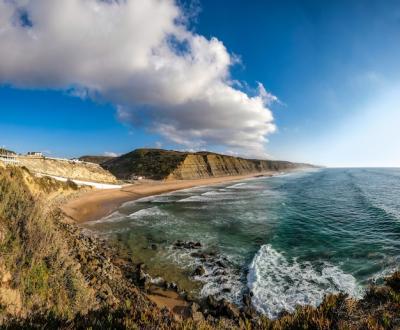 Coastline surrounded by rocky mountains under the blue sky