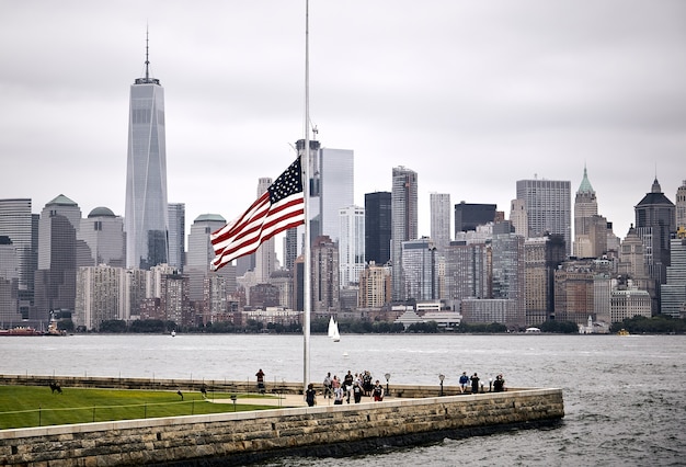 US Flag in a Park with Manhattan Skyline Background