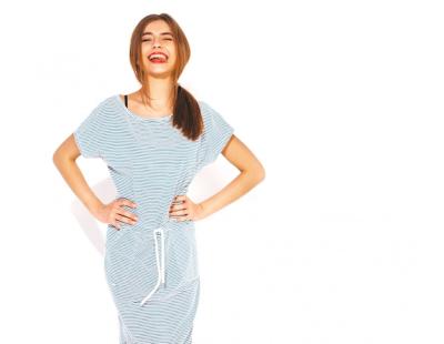 Young beautiful woman looking.Trendy girl in casual summer zebra dress. Positive funny model. Showing tongue